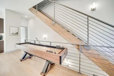 a staircase with a ping pong table in a room at Rooftop Mtn View and Hot Tub Silverthorne Home! in Silverthorne
