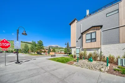 a stop sign on a street next to a building at Rooftop Mtn View and Hot Tub Silverthorne Home! in Silverthorne