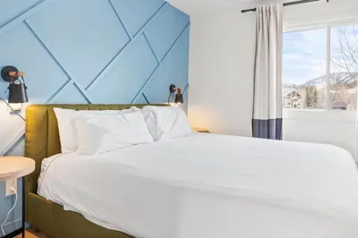 a bedroom with a large bed and a window at Stylish 2BR Near Trails and Slopes in Dillon