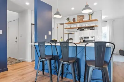 a kitchen with a blue counter and four chairs at Stylish 2BR Near Trails and Slopes in Dillon