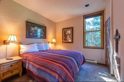 a bedroom with a large bed and a window at Keystone W Magical View Walk to Ski Lift in Keystone