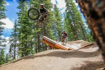 two people on bikes jumping over a ramp at Keystone W Magical View Walk to Ski Lift in Keystone