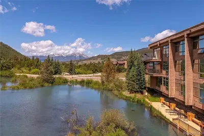 a view of a river next to a building at Keystone W Magical View Walk to Ski Lift in Keystone
