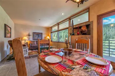 a dining room with a table and chairs in a room at Keystone W Magical View Walk to Ski Lift in Keystone