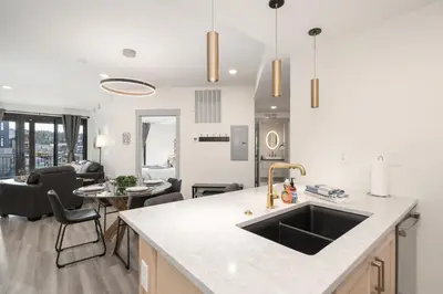 a kitchen with a sink and a living room at Ski Idlewild condo in Winter Park