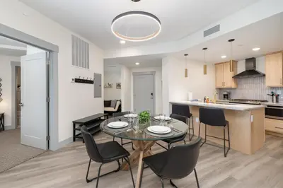 a kitchen and dining room with a table and chairs at Ski Idlewild condo in Winter Park