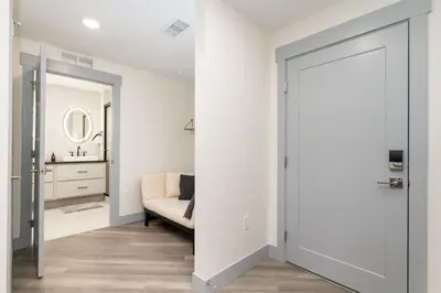 a living room with a couch and a mirror at Ski Idlewild condo in Winter Park