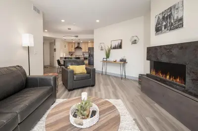 a living room with a couch and a fireplace at Ski Idlewild condo in Winter Park