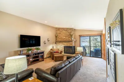 a living room with a leather couch and a fireplace at Lake Cliffe 303 Building E in Dillon