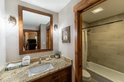 a bathroom with a sink and a toilet and a mirror at Lake Cliffe 303 Building E in Dillon