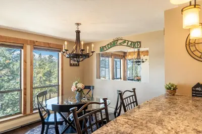 a dining room with a table and a chandelier at Lake Cliffe 303 Building E in Dillon