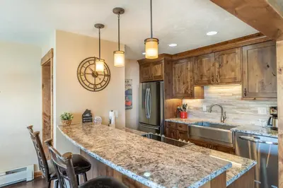 a kitchen with wooden cabinets and a large counter top at Lake Cliffe 303 Building E in Dillon