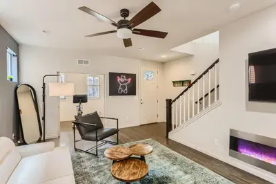 a living room with a couch and a ceiling fan at 2226 N Washington St in Denver