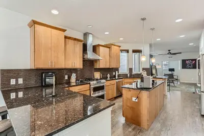 a large kitchen with wooden cabinets and a counter top at 2226 N Washington St in Denver