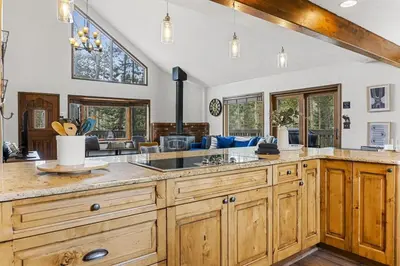 a large kitchen with wooden cabinets and a large island at Peaceful 5BR Retreat with Hot Tub in Breckenridge