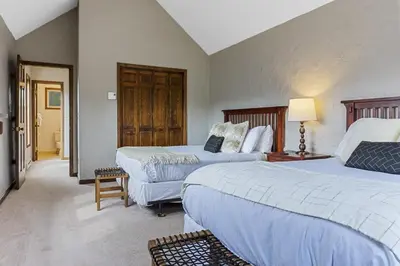 a hotel room with two beds and a table at Peaceful 5BR Retreat with Hot Tub in Breckenridge