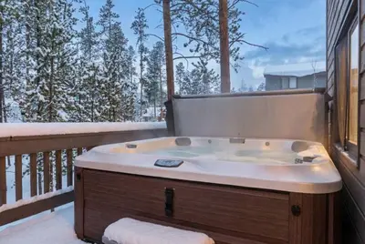 a jacuzzi tub on the balcony of a house at Peaceful 5BR Retreat with Hot Tub in Breckenridge