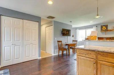 a kitchen with a door and a table with chairs at 12 Mi to Denver Golden Vacation Rental! in Golden