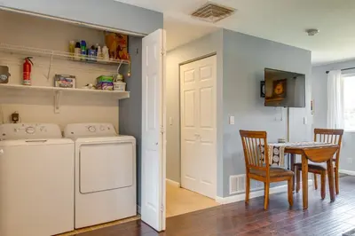 a laundry room with a washing machine and a table at 12 Mi to Denver Golden Vacation Rental! in Golden