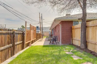 a backyard with a wooden fence and a lawn at 12 Mi to Denver Golden Vacation Rental! in Golden