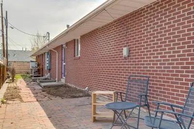 a brick building with two chairs and a table at 12 Mi to Denver Golden Vacation Rental! in Golden