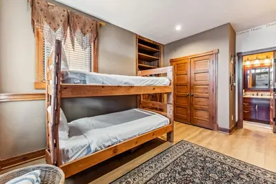 a bedroom with two bunk beds and a doorway at Luxurious 4BR Retreat with Hot Tub Near Gold Course in Breckenridge