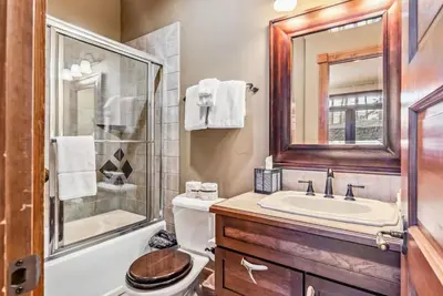 a bathroom with a toilet and a sink and a shower at Luxurious 4BR Retreat with Hot Tub Near Gold Course in Breckenridge