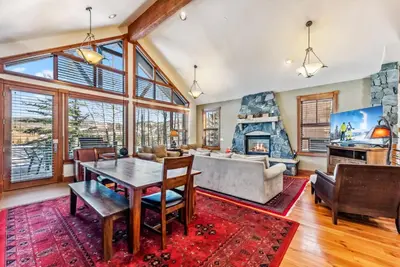 a living room with a table and a fireplace at Luxurious 4BR Retreat with Hot Tub Near Gold Course in Breckenridge