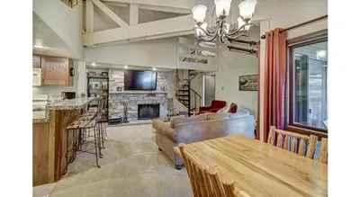 a living room with a couch and a table at Updated 2Br Plus Loft Condo on Shuttle Route! Sleeps 8 & Kids Ski Free condo in Montezuma