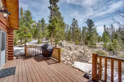 a wooden deck with a grill on it at Mountain-View Front Range Colorado Vacation Rental in Red Feather Lakes