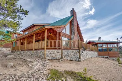 a log home with a wrap around deck at Mountain-View Front Range Colorado Vacation Rental in Red Feather Lakes