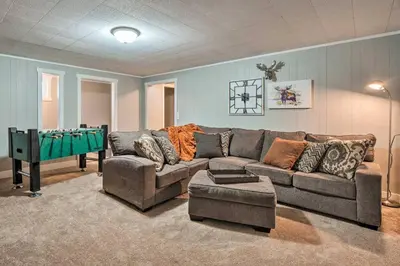 a living room with a couch and a pool table at 4 bed 2 bath home located near Rocky Mountain National Park in Estes Park