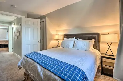a bedroom with a blue and white bed with two lamps at 4 bed 2 bath home located near Rocky Mountain National Park in Estes Park