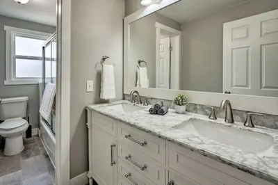 a bathroom with a sink and a toilet and a mirror at 4 bed 2 bath home located near Rocky Mountain National Park in Estes Park