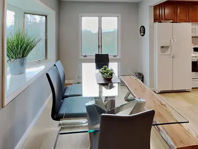a dining room with a glass table and a refrigerator at Stunning 3BR central to Breck Keystone Copper in Silverthorne