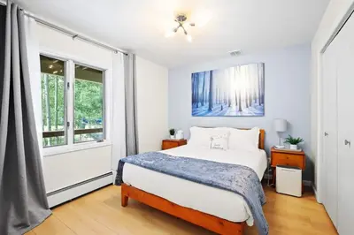 a bedroom with a bed and a window at Stunning 3BR central to Breck Keystone Copper in Silverthorne