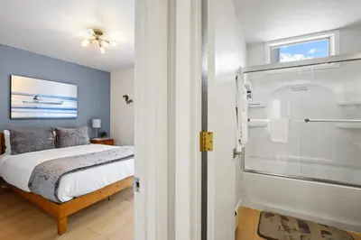 a bedroom with a bed and a walk in shower at Stunning 3BR central to Breck Keystone Copper in Silverthorne