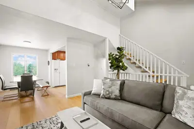 a living room with a couch and a staircase at Stunning 3BR central to Breck Keystone Copper in Silverthorne
