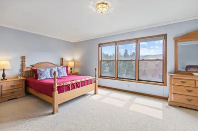 a bedroom with a bed and a large window at Homey 3BR Near Lake Dillon with Mountain Views in Dillon