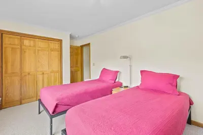 two beds in a room with pink sheets at Homey 3BR Near Lake Dillon with Mountain Views in Dillon