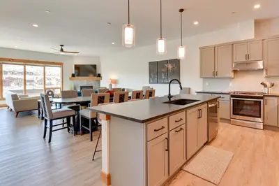 a kitchen and dining room with a table and chairs at Fraser Getaway with Deck Near Winter Park Resort! in Fraser