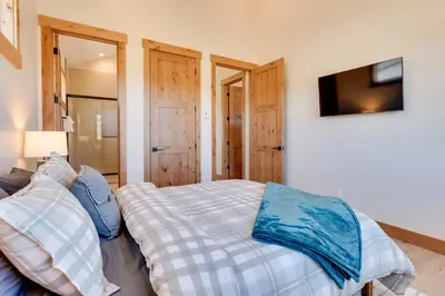 a bedroom with a bed and a tv in at Fraser Getaway with Deck Near Winter Park Resort! in Fraser