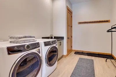a washer and dryer sitting in a laundry room at Fraser Getaway with Deck Near Winter Park Resort! in Fraser