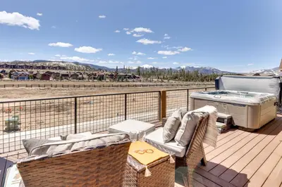 a patio with a hot tub and a grill on a deck at Fraser Getaway with Deck Near Winter Park Resort! in Fraser