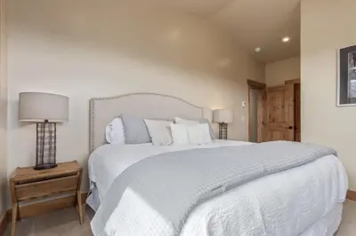 a bedroom with a large bed with white sheets and pillows at Incredible 3BR Tranquil Setting & Space to Spare in Silverthorne