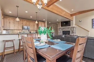 a kitchen and dining room with a wooden table and chairs at Incredible 3BR Tranquil Setting & Space to Spare in Silverthorne