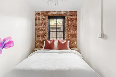 a bed in a room with a brick wall at The Acoma House in Denver