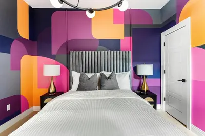 a bedroom with a bed and colorful walls at The Acoma House in Denver