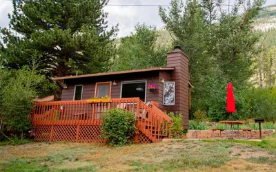 a small house with a fence in front of it at McGregor Mountain Lodge in Estes Park