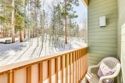 a porch with a chair and a view of the snow at Convenient Winter Park, Colorado, Vacation Rental! in Winter Park
